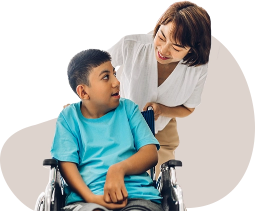 Child in a wheelchair with his carer.